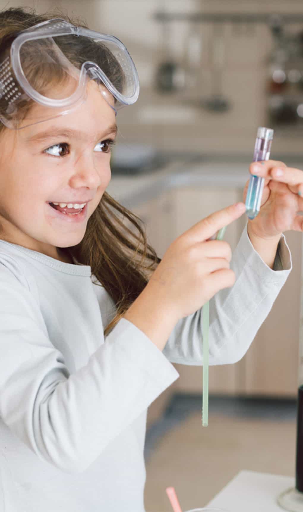 Child doing science at home in the kitchen.