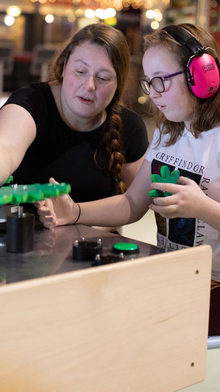 Mother and child in Life's creativity zone. The child is wearing ear defenders.