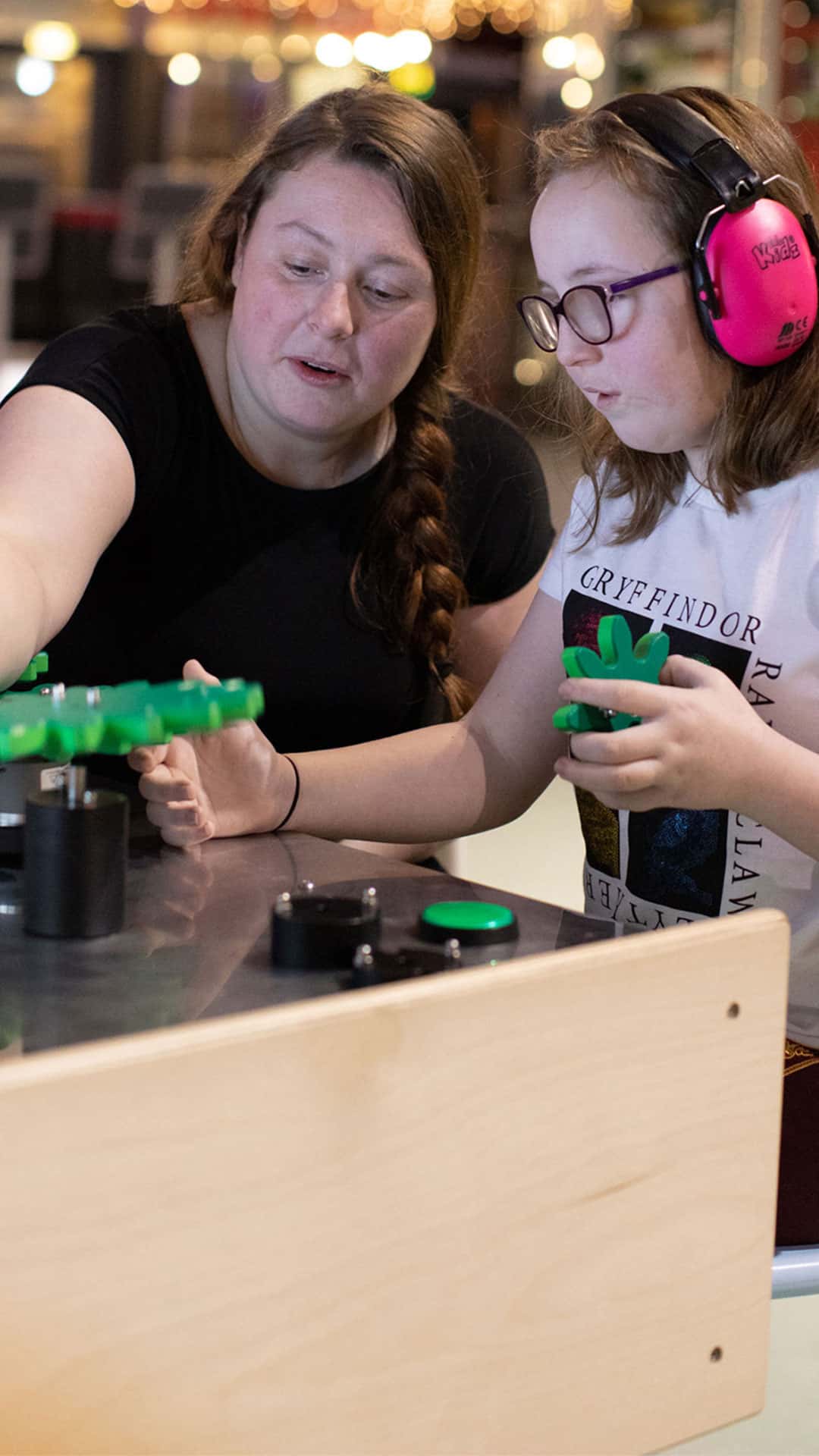 Mother and child in Life's creativity zone. The child is wearing ear defenders.