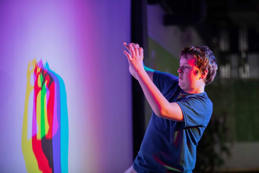Visitor interacting with sensory wall at a Relaxed Sunday Session inside the science centre.