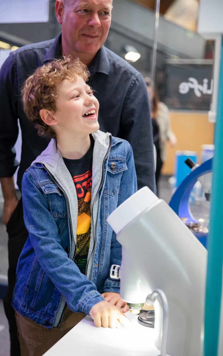 Father and son enjoying hands-on activity in Life Science Centre's Experiment Zone.