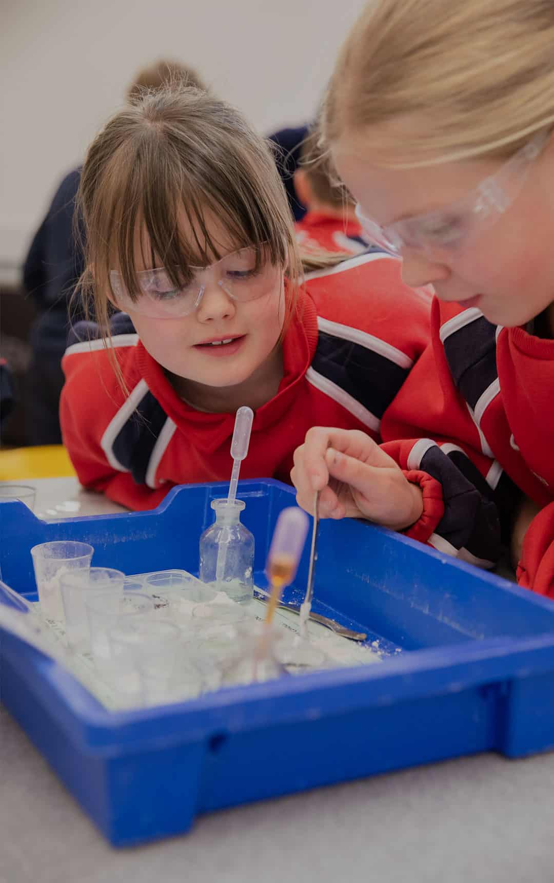 Two female school students using pipette during Life Science Centre education workshop.
