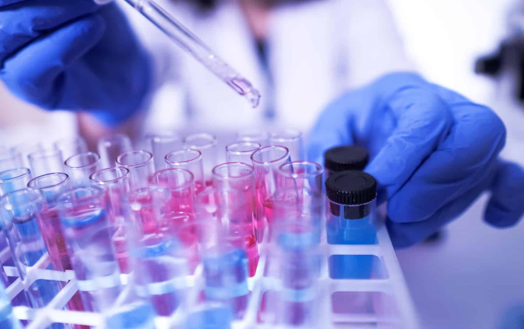 Female lab technician doing research with a microscope in the lab. coronavirus stock photo
