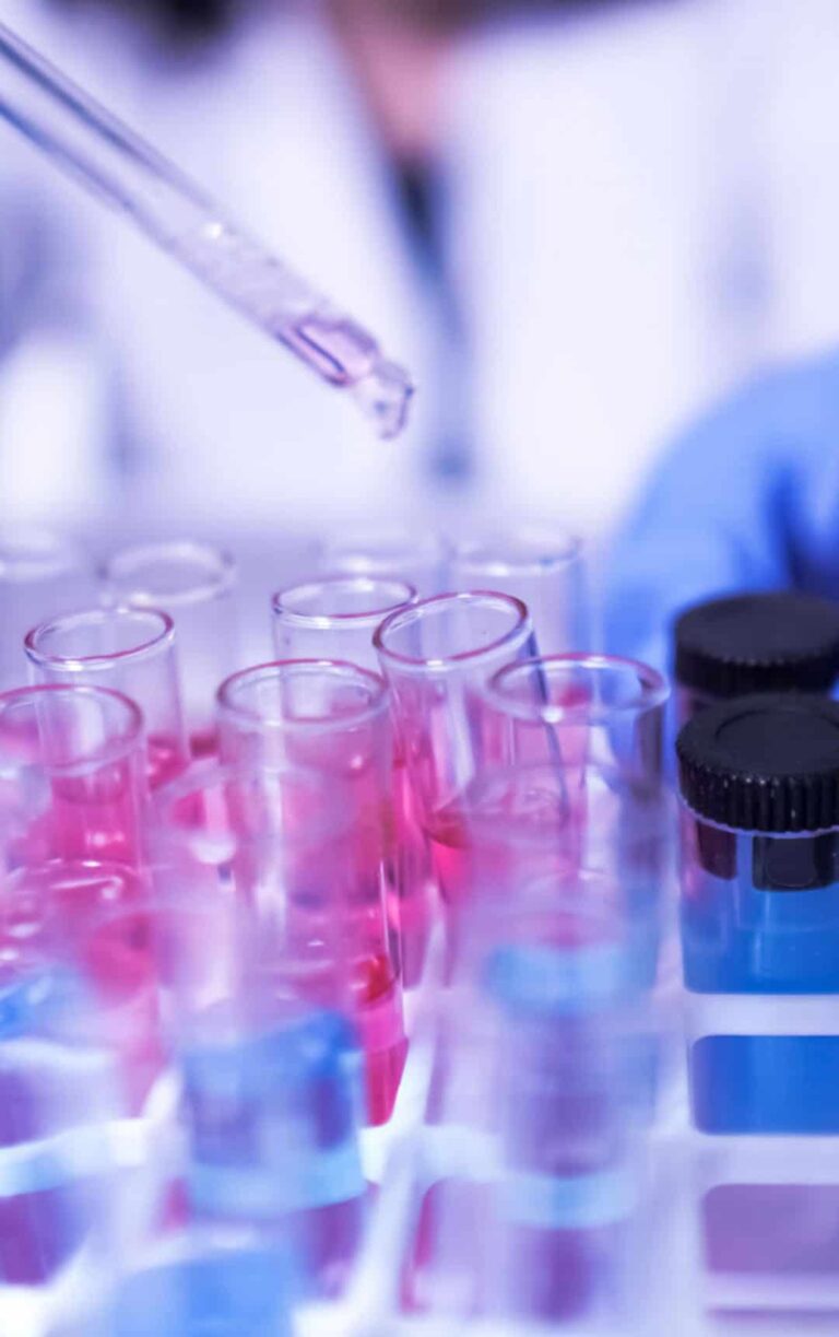 Female lab technician doing research with a microscope in the lab. coronavirus stock photo