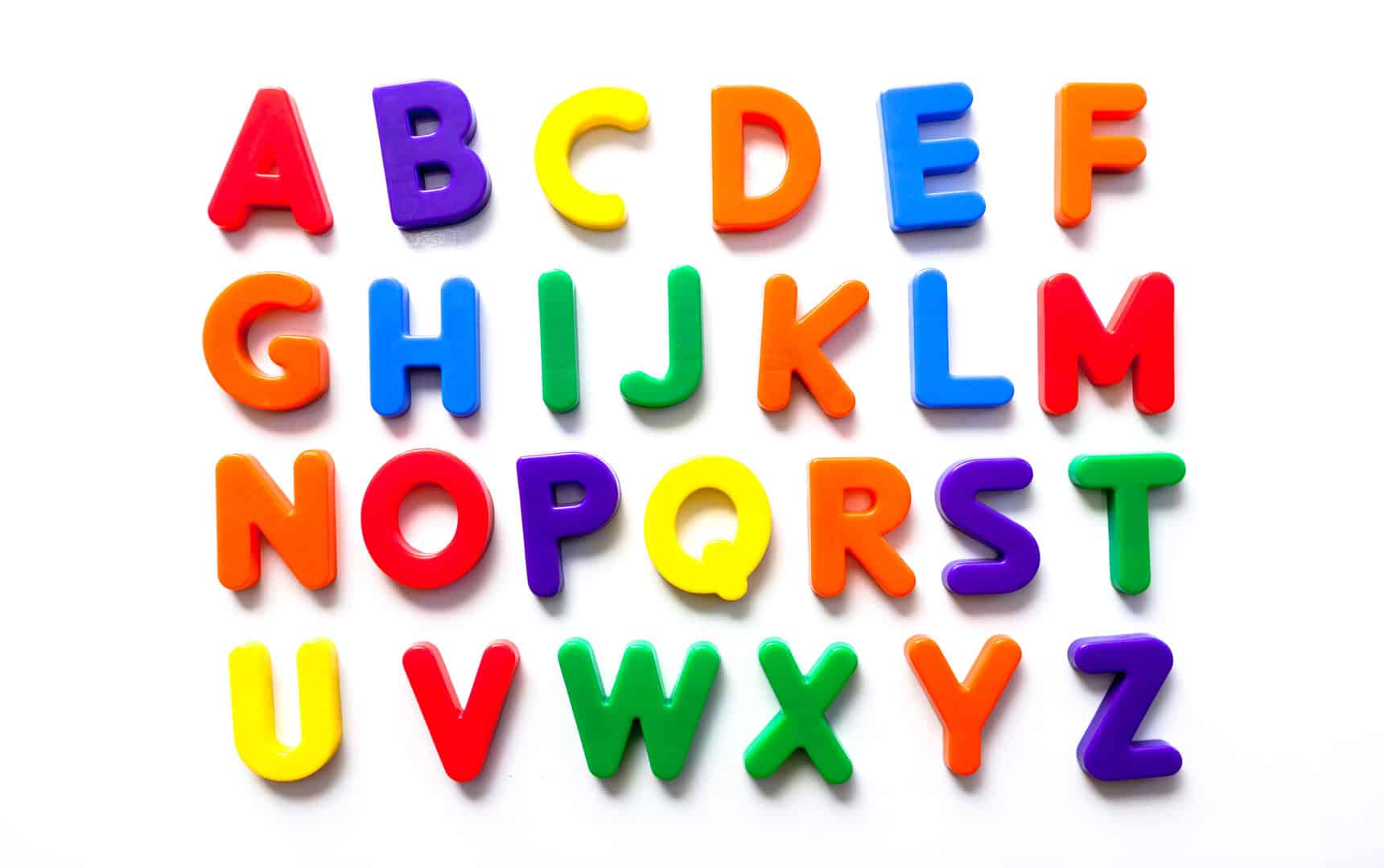 Alphabet in vintage colorful refrigerator magnets stock photo