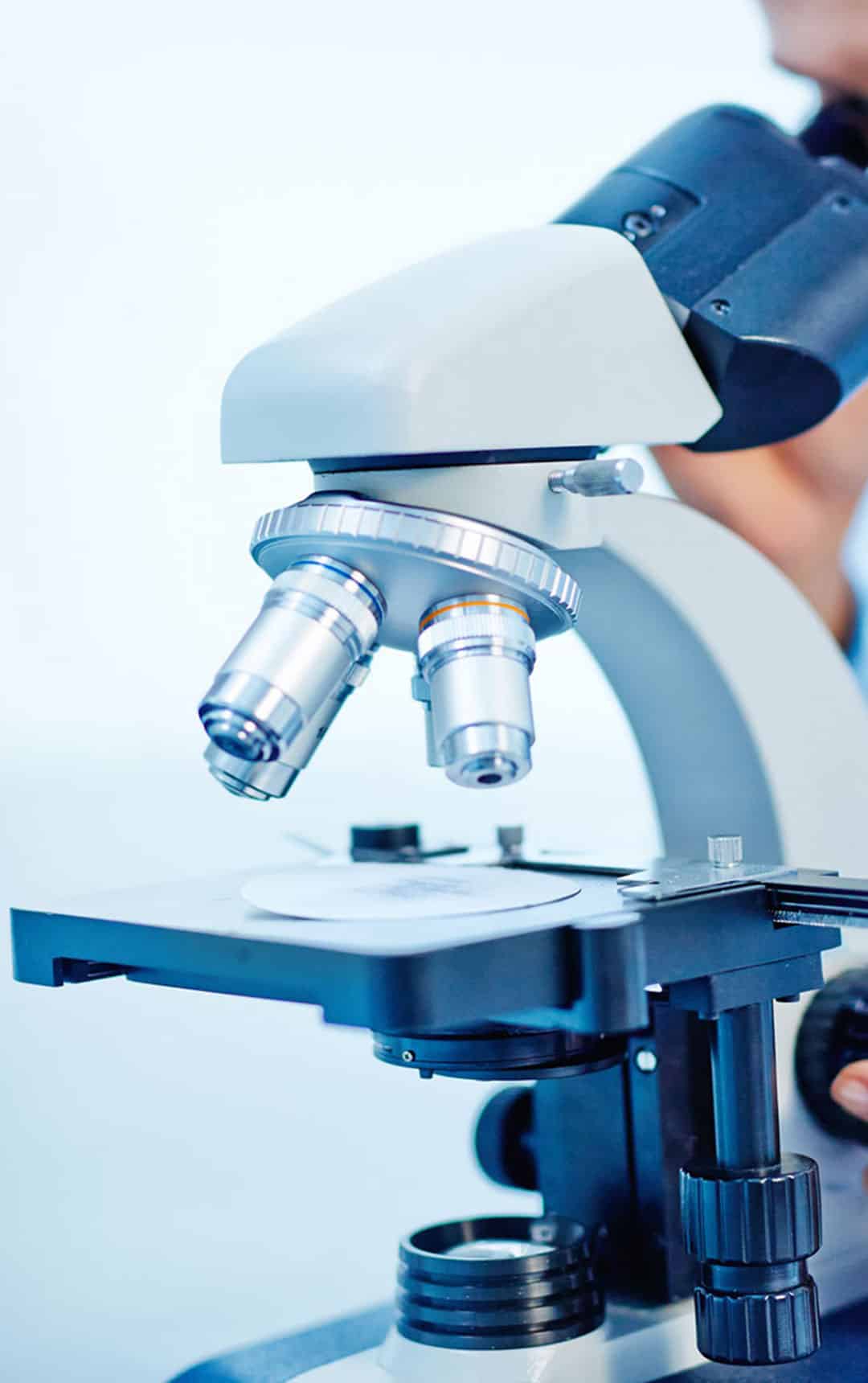 Young female chemist studying new substance in lab