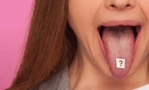Female office worker with drug on the end of tongue with question mark symbol.
