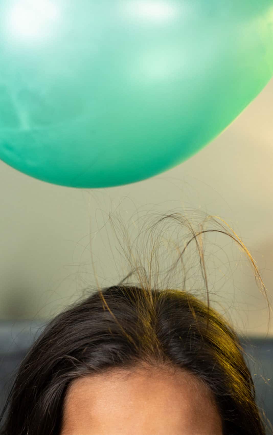Close Up Shot Of Kids Playing By Placing Balloon To Attracting Hair Concept Of Static Cling Home Science Experiment And Learning.