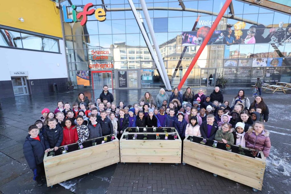 School children outside Life Science Centre's bee friendly planters.