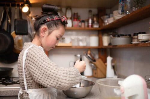 Girl extracting DNA from fruit and vegetables in kitchen at home.