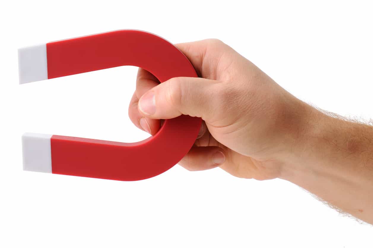Hand holding a magnet.