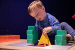 Little boy playing with building blocks at Life Science Centre Pre-School Day.