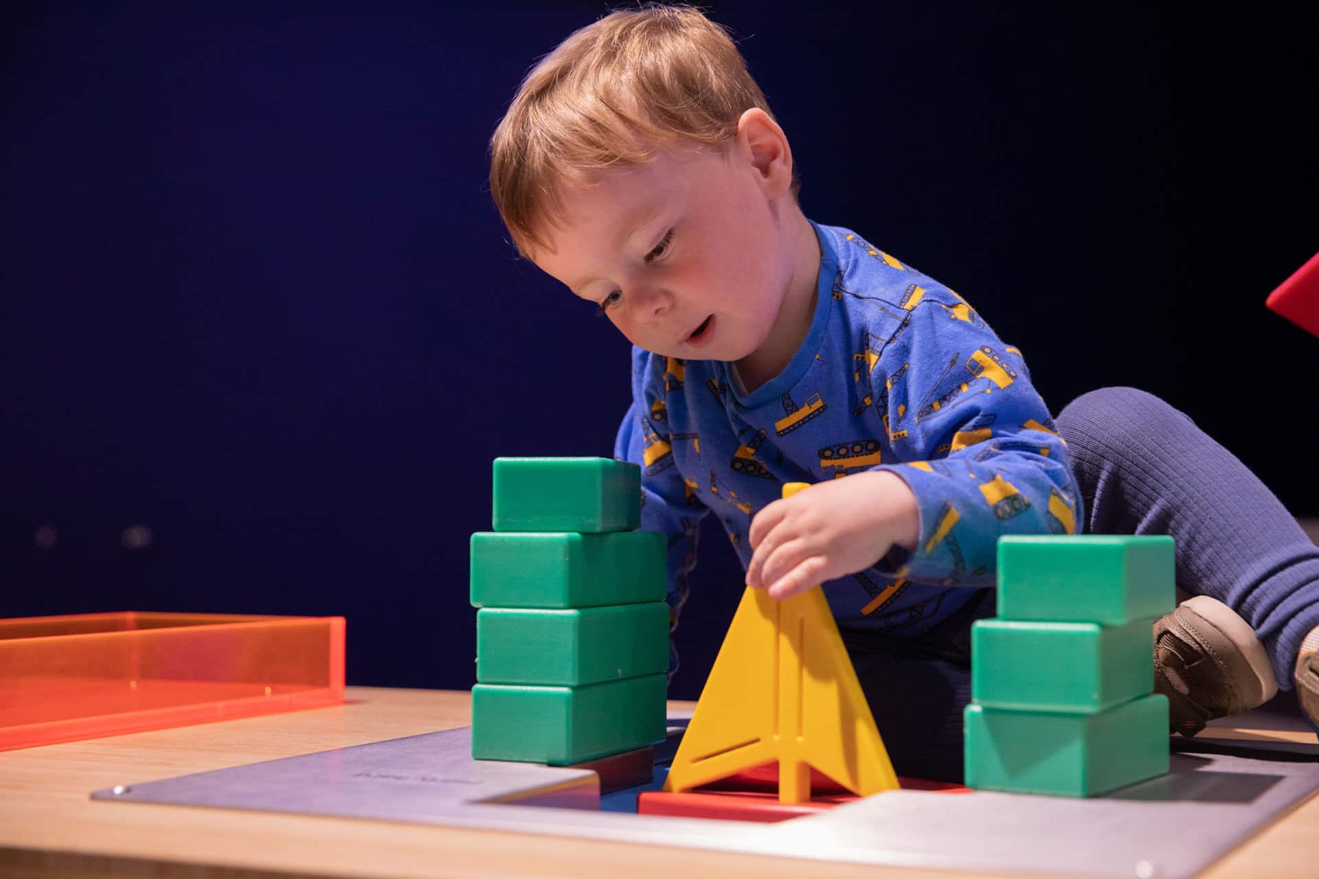 Little boy playing with building blocks at Life Science Centre Pre-School Day.