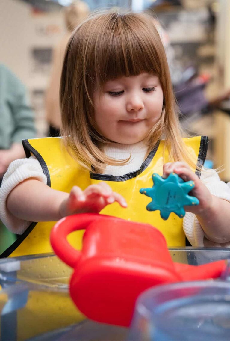 Little girl enjoying water play at a Life Science Centre Pre-School Day.
