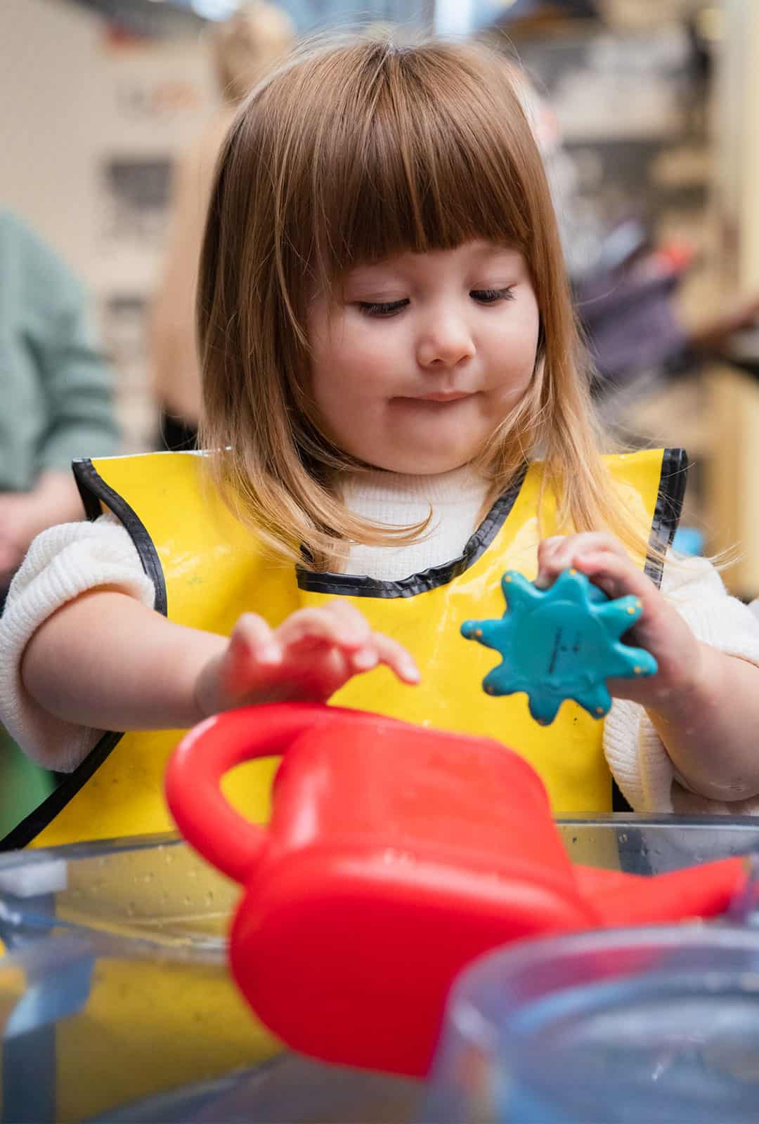 Little girl enjoying water play at a Life Science Centre Pre-School Day.