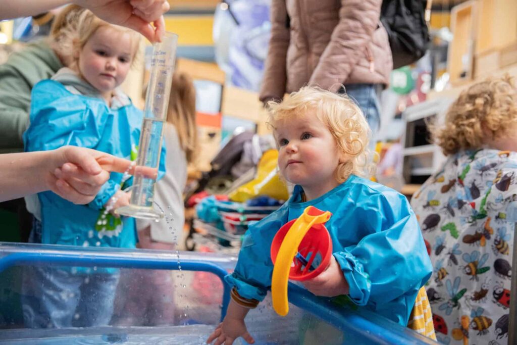 Toddler Playing With Water at a Life Science Centre Pre-School Day.