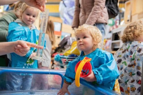 Toddler Playing With Water at a Life Science Centre Pre-School Day.