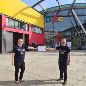 Project leads from North East Autism Society and Life Science Centre standing outside of the centre with Gold Standard Award.