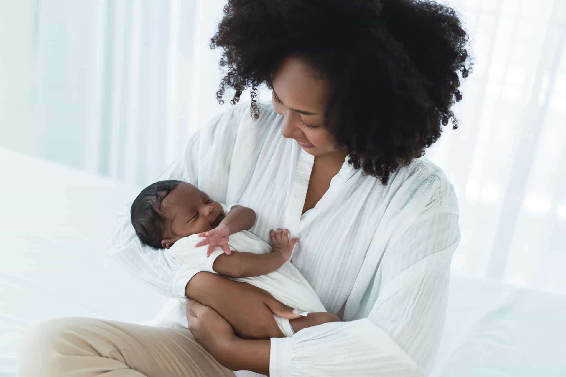 Mother with newborn child, thanks to the research at the NHS Fertility Clinic, which operates on the Life site.