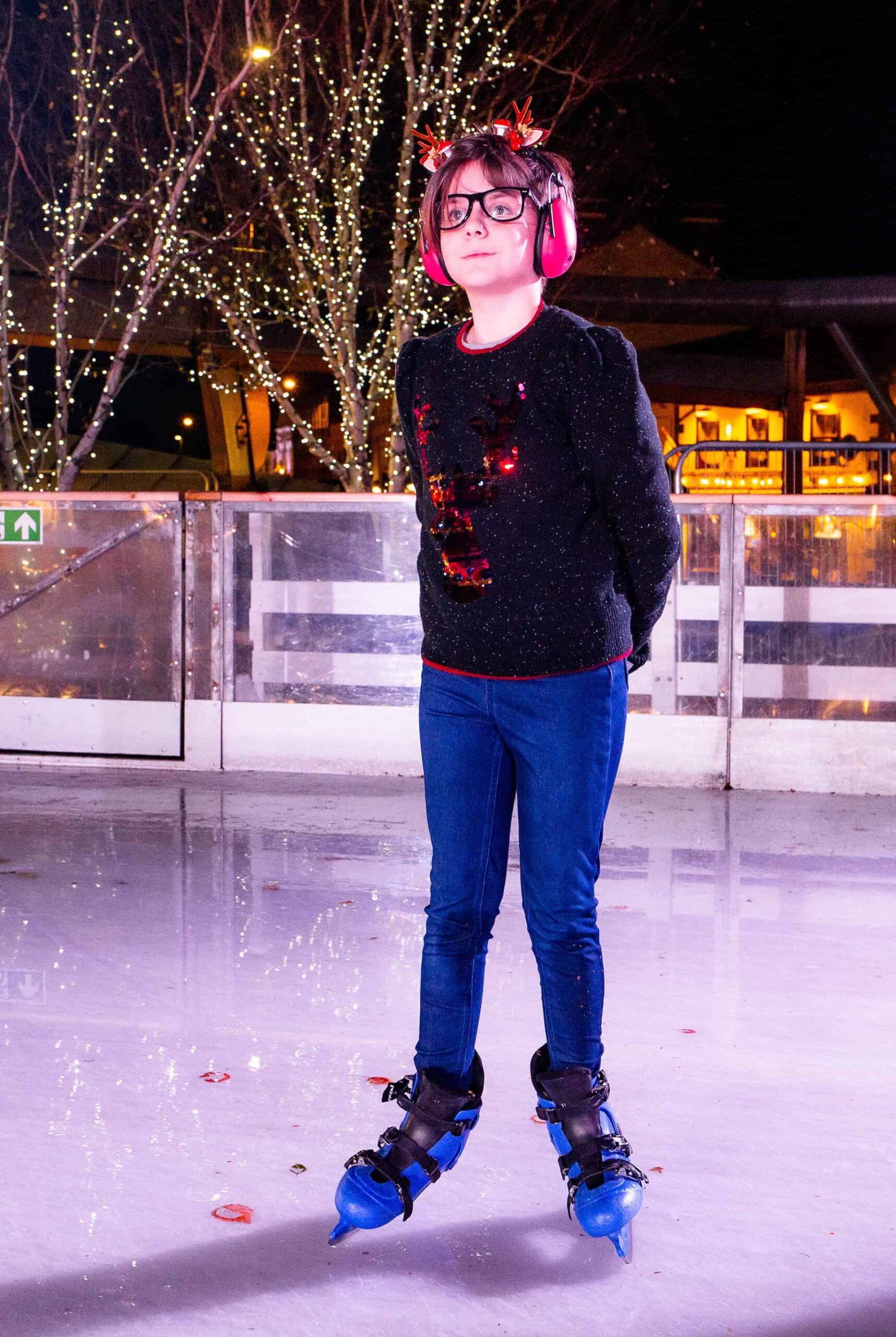 Child wearing ear defenders on Life Science Centre's open-air ice rink.