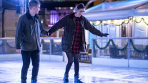 Couple holding hands whilst skating on Newcastle's open-air ice rink.