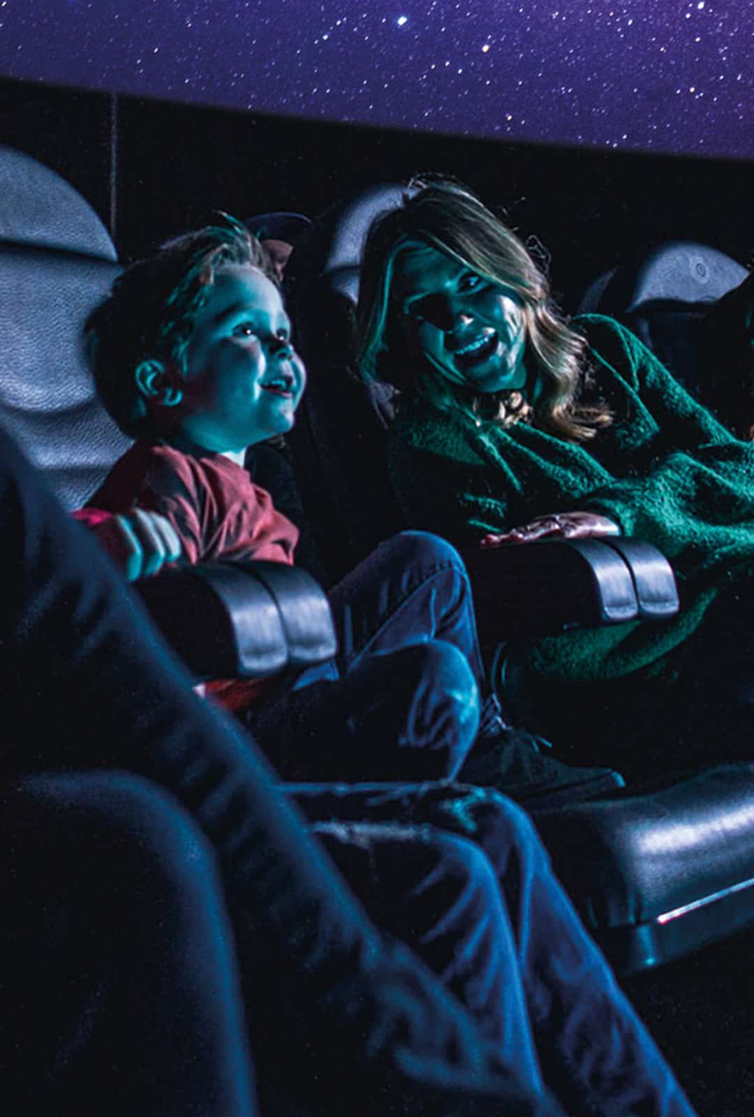 Mother and son in Just Look Up Planetarium Show at Life Science Centre.
