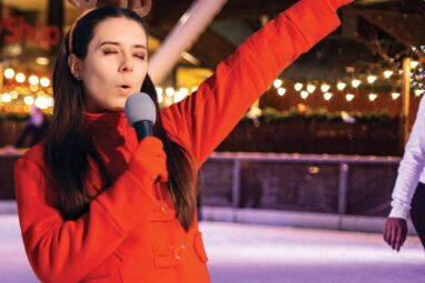 Lady singing at Newcastle's Karaoke event on ice rink.