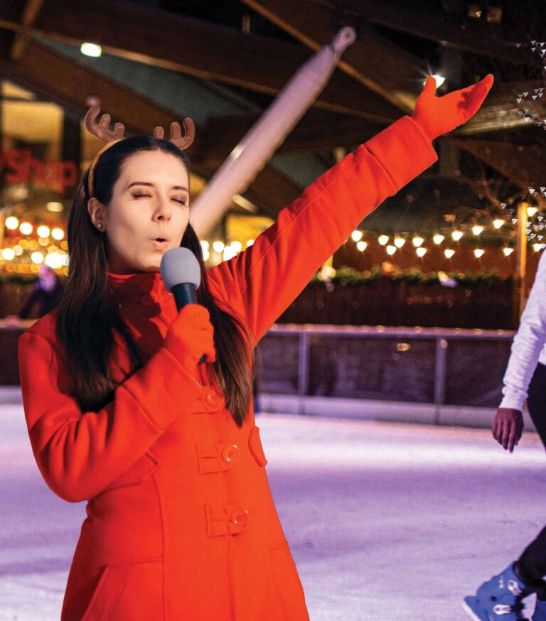 Lady singing at Newcastle's Karaoke event on ice rink.