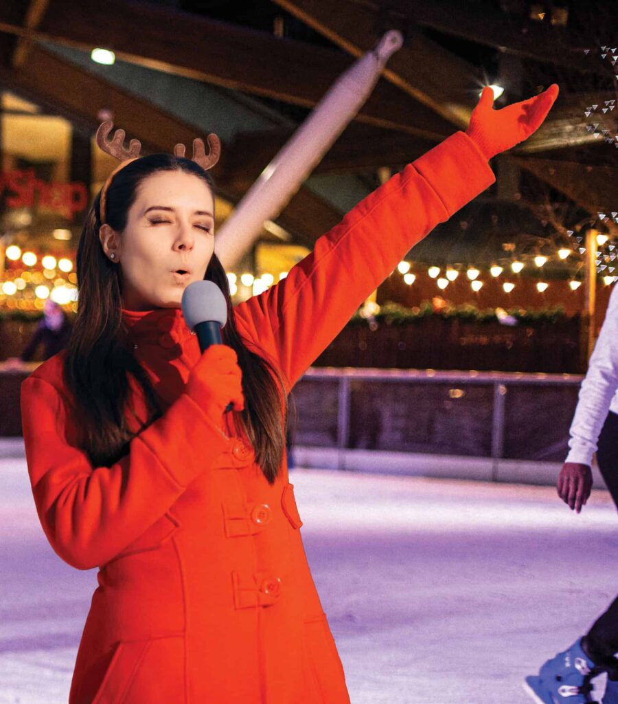 Lady singing at Newcastle's Karaoke event on ice rink.