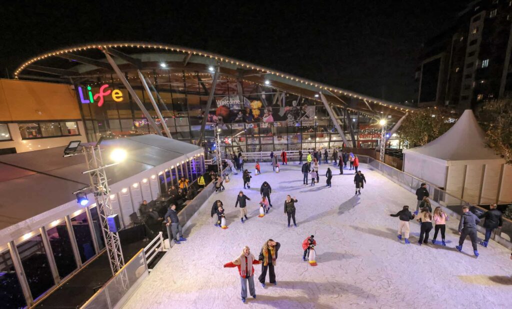 Overhead photo of Life Science Centre's outdoor icerink with skaters in Newcastle.