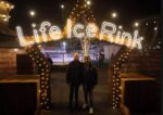 Couple stood at the ice rink star entrance in Newcastle.
