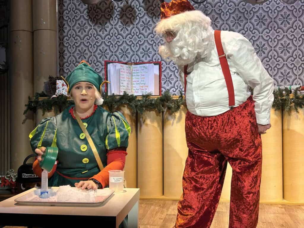 Santa and elf doing fun science demonstration at Life Science Centre.