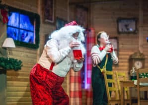 Santa and Elf doing festive science experiment in Santa's grotto at Life Science Centre.