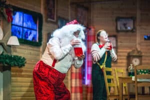 Santa and Elf doing festive science experiment in Santa's grotto at Life Science Centre.
