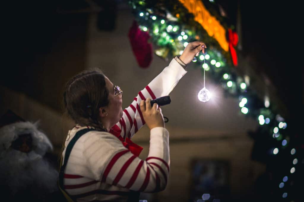 Santa's Elf doing an experiment about light fragmentation with a torch and crystal at Newcastle's Life Science Centre
