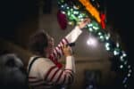 Santa's Elf doing an experiment about light fragmentation with a torch and crystal at Newcastle's Life Science Centre