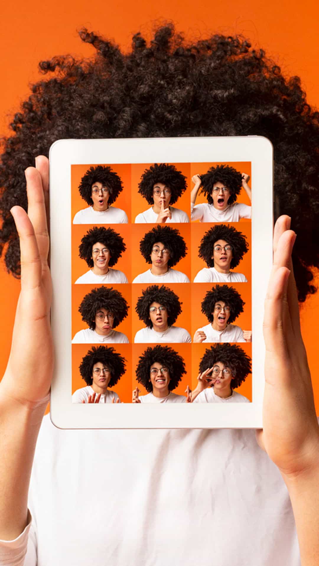 Teenager holding iPad with portraits of 16 emotions being displayed.