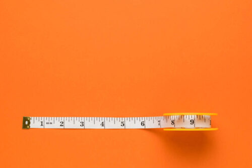 Scientific tape measure on an orange background
