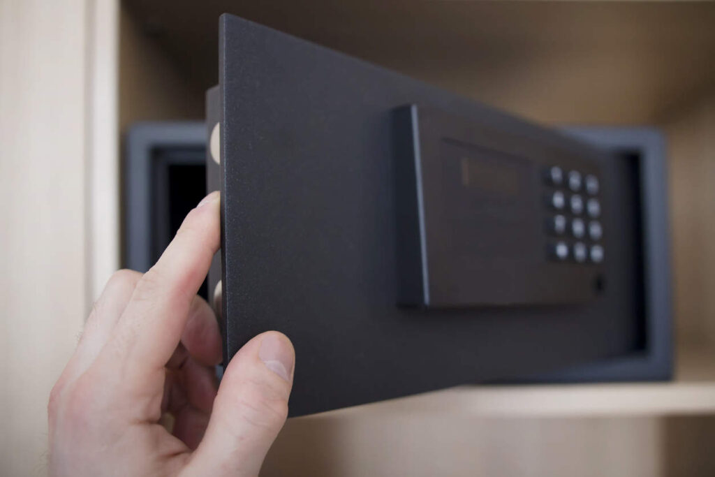 Man Opens Safe Depository Of Valuables And Money In His Home. Keep The Money In The Safe At Home. Safe, Hand Close Up.
