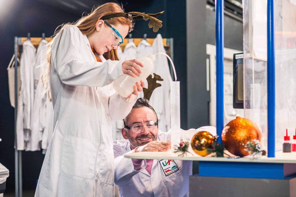 Father and daughter completing festive experiment at Life Science Centre in Newcastle.