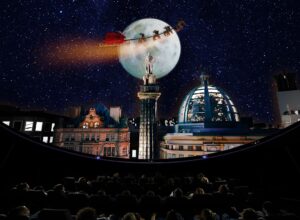 Overhead shot of santa flying over Newcastle skyline during 'What Santa Sees' planetarium show.