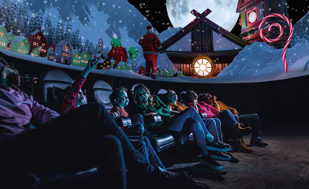 A family in the planetarium watching What Santa Sees