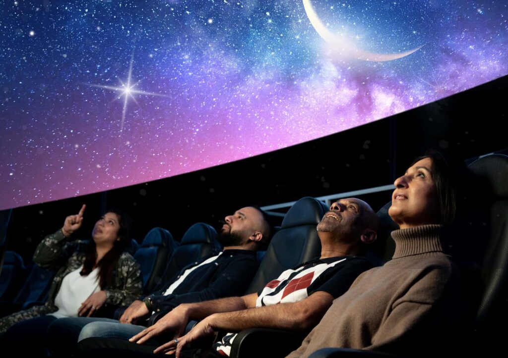 Adults sat in Life Science Centre's huge planetarium, looking up to watch Live Skies Show.