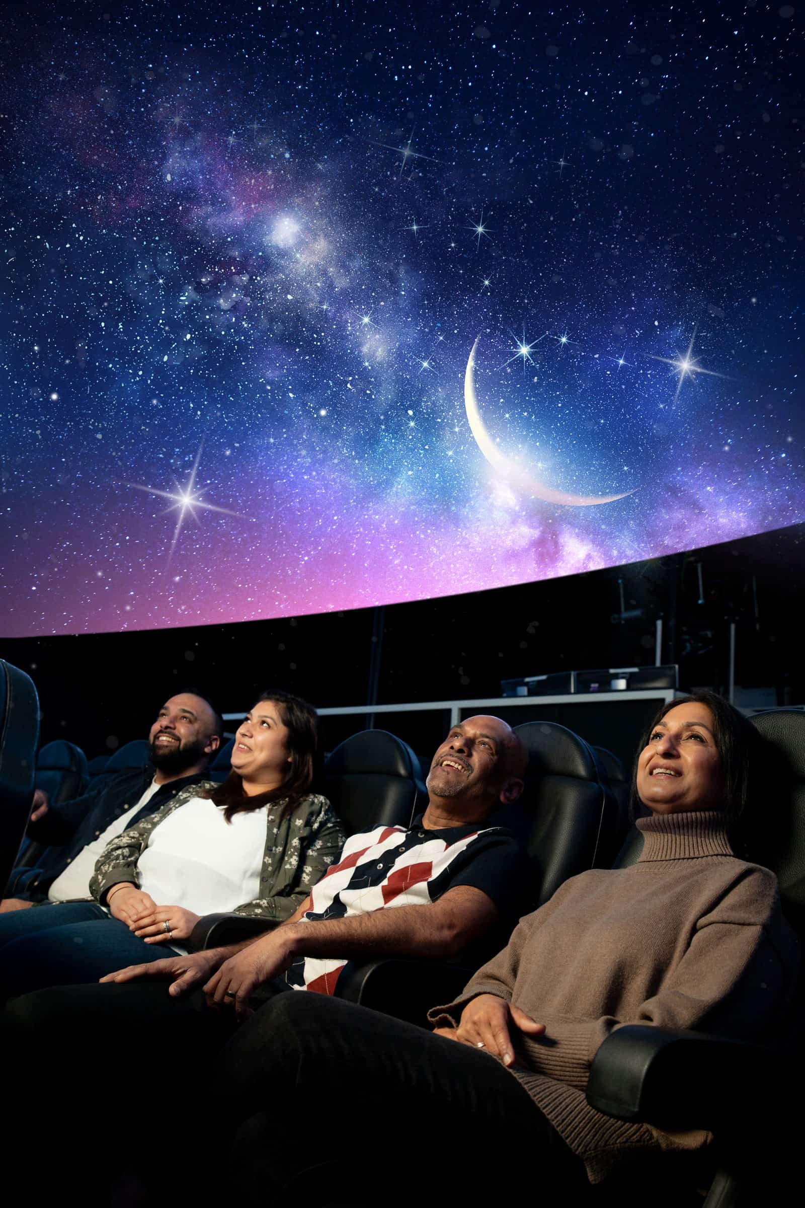 Adults sat in Life Science Centre's huge planetarium, looking up to watch Live Skies Show.