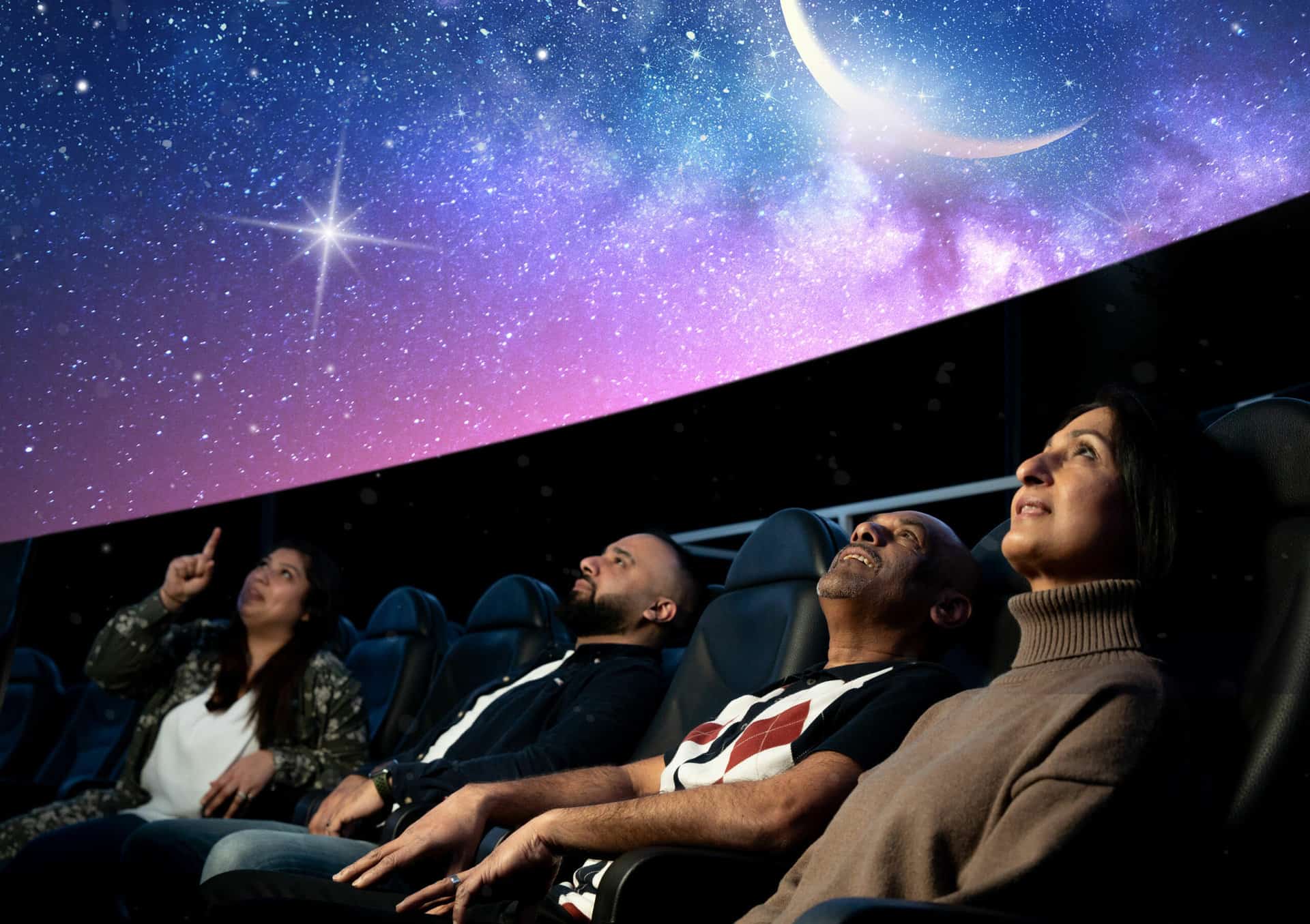 Adults sat in Life Science Centre's huge planetarium, looking up to watch Live Skies Show.