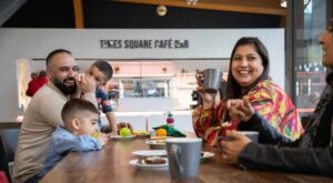 Family enjoying a hot drink in Times Square Cafe Bar at Life Science Centre.