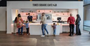 Family ordering food at Times Square Cafe Bar reception in Life Science Centre.