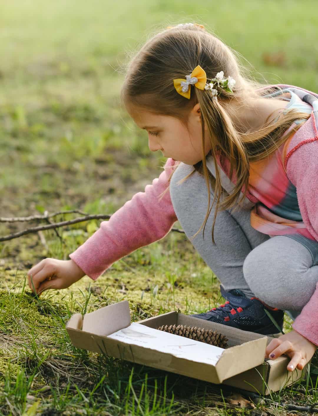 Young child outside exploring nature, participating in Life Science Centre Summer Scavenger Hunt