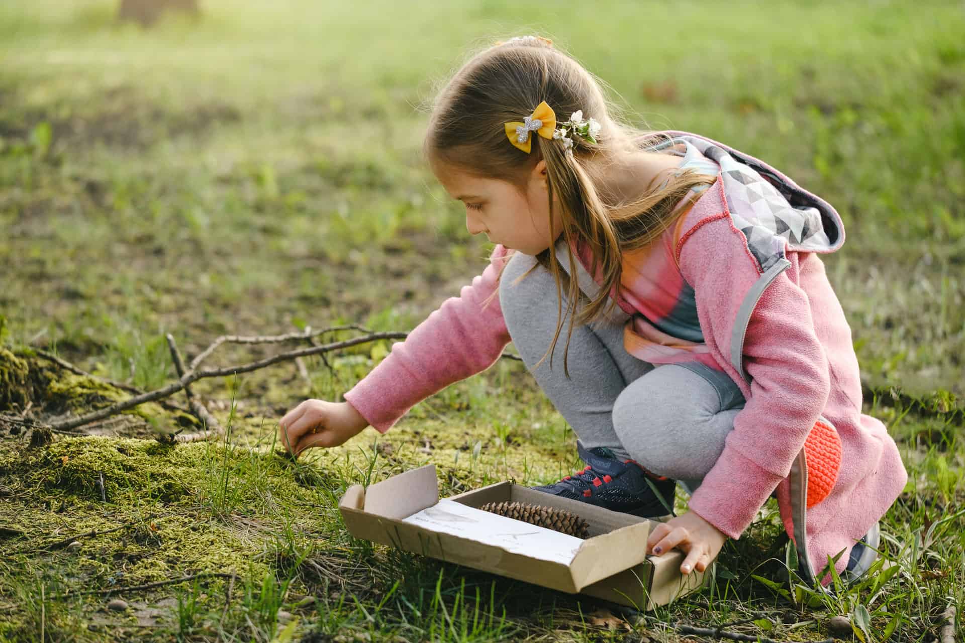 Young child outside exploring nature, participating in Life Science Centre Summer Scavenger Hunt