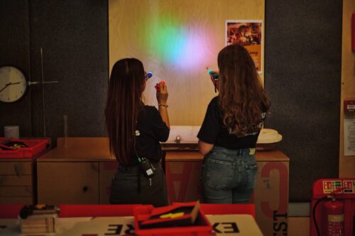 Two team members showing light demonstration in Home Education workshop.